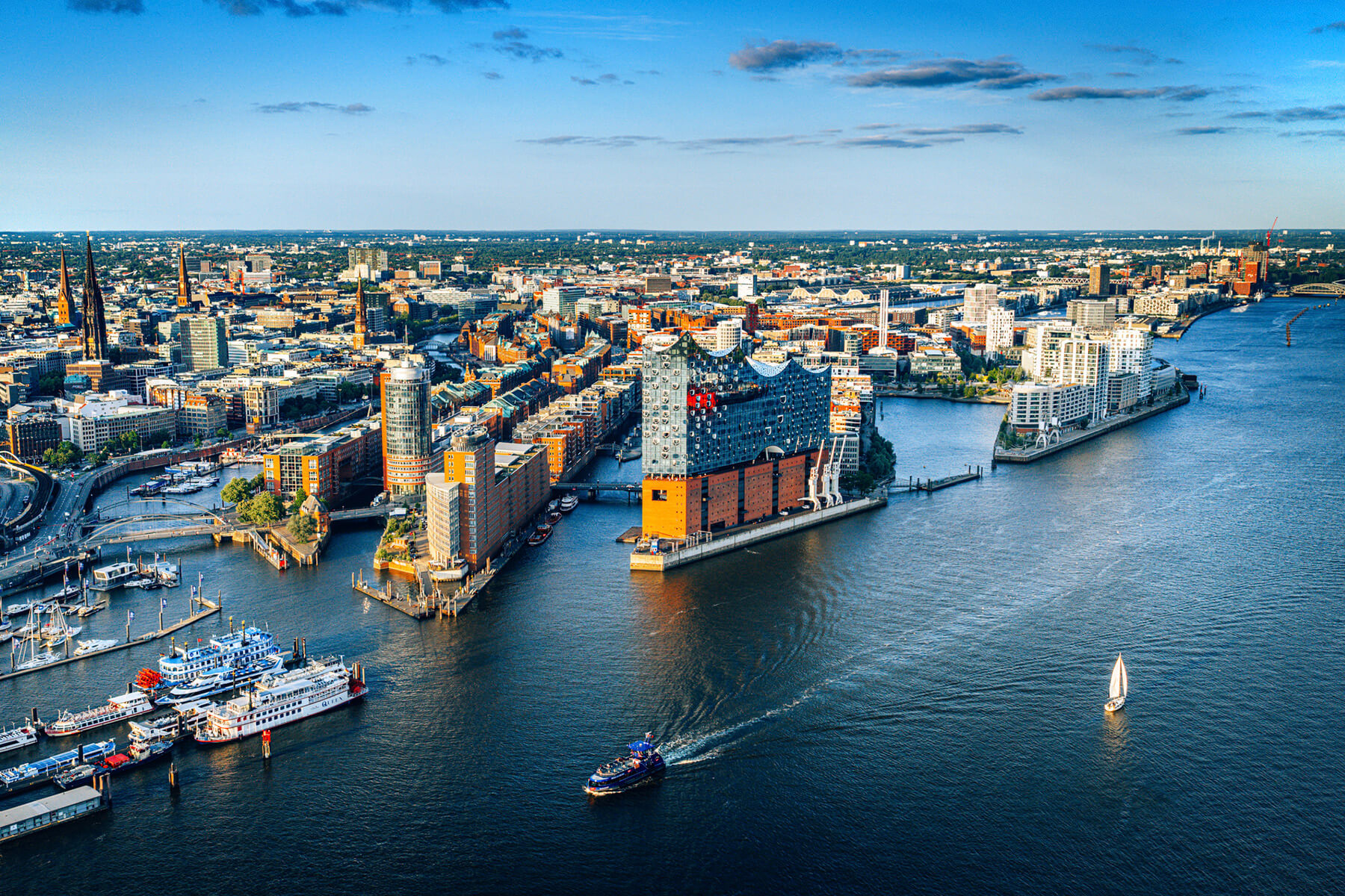 Blick &uuml;ber die Hamburger HafenCity mit Elbphilharmonie, Speicherstadt und der Elbe, im Vordergrund Barkassen an den Landungsbr&uuml;cken